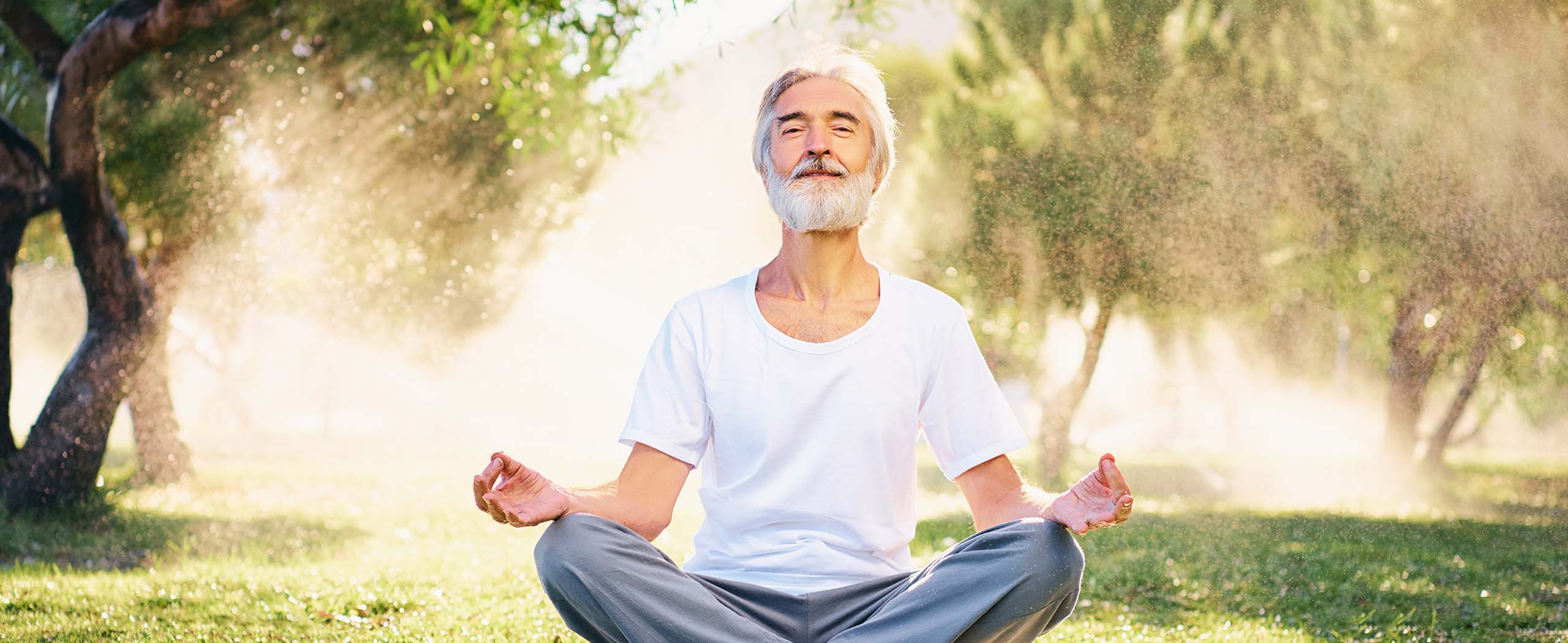 middle-aged man meditating outdoors
