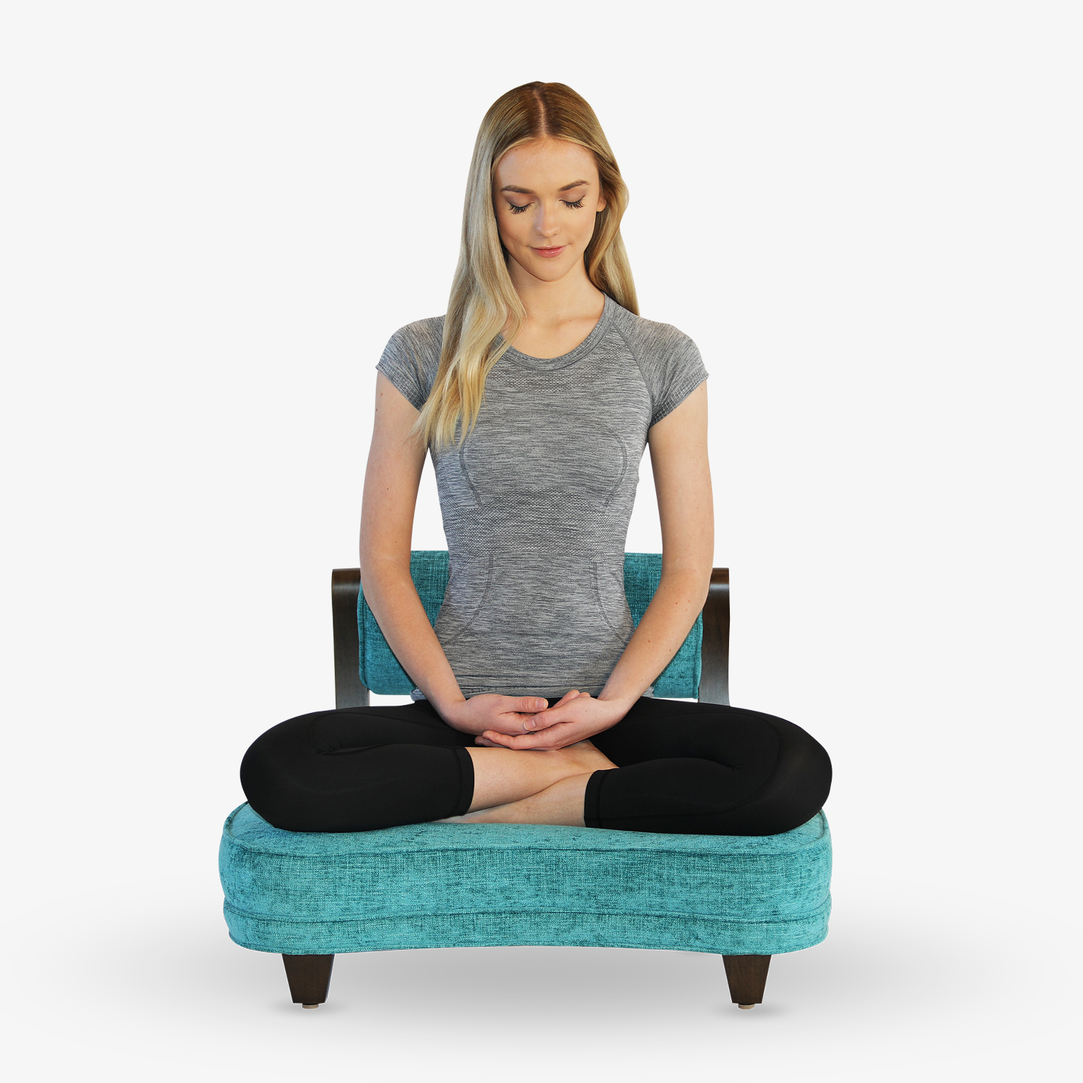 A woman meditating in The Rama Meditation Chair in the full lotus pose.
